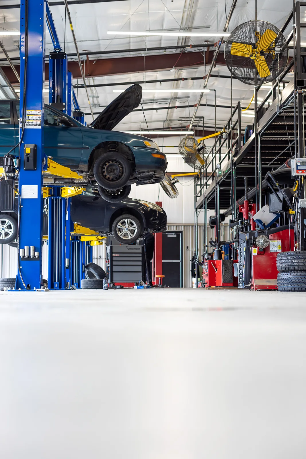 Fast Track Tire and Service service bay with vehicles on lifts